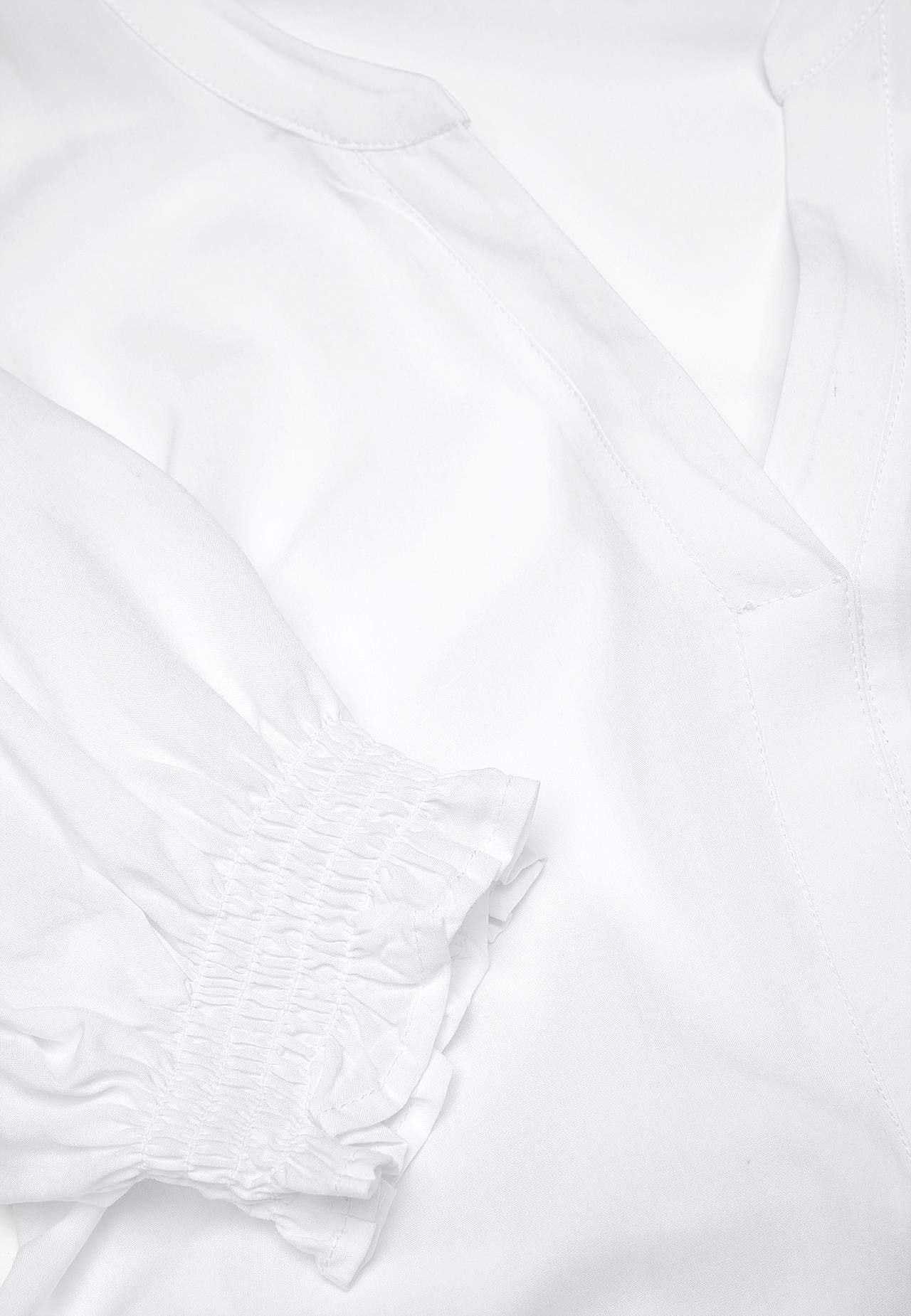 Tunic with smocking on the sleeve ends