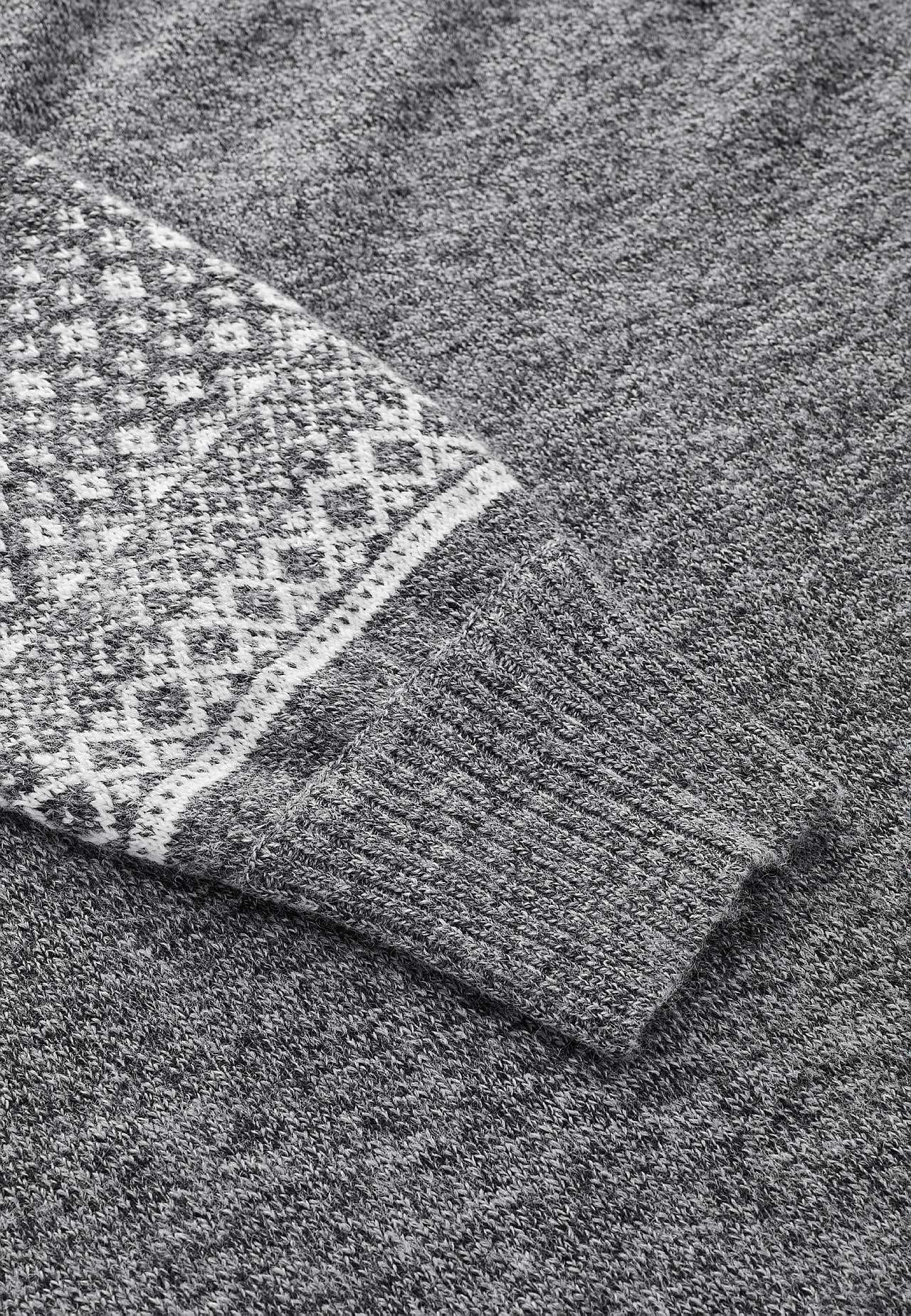Knitted dress with jacquard patterned sleeves