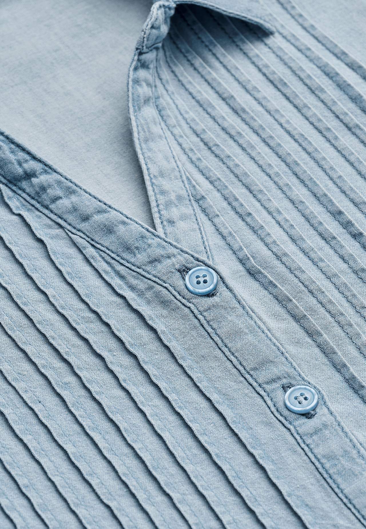 Denim blouse with sewn pleats