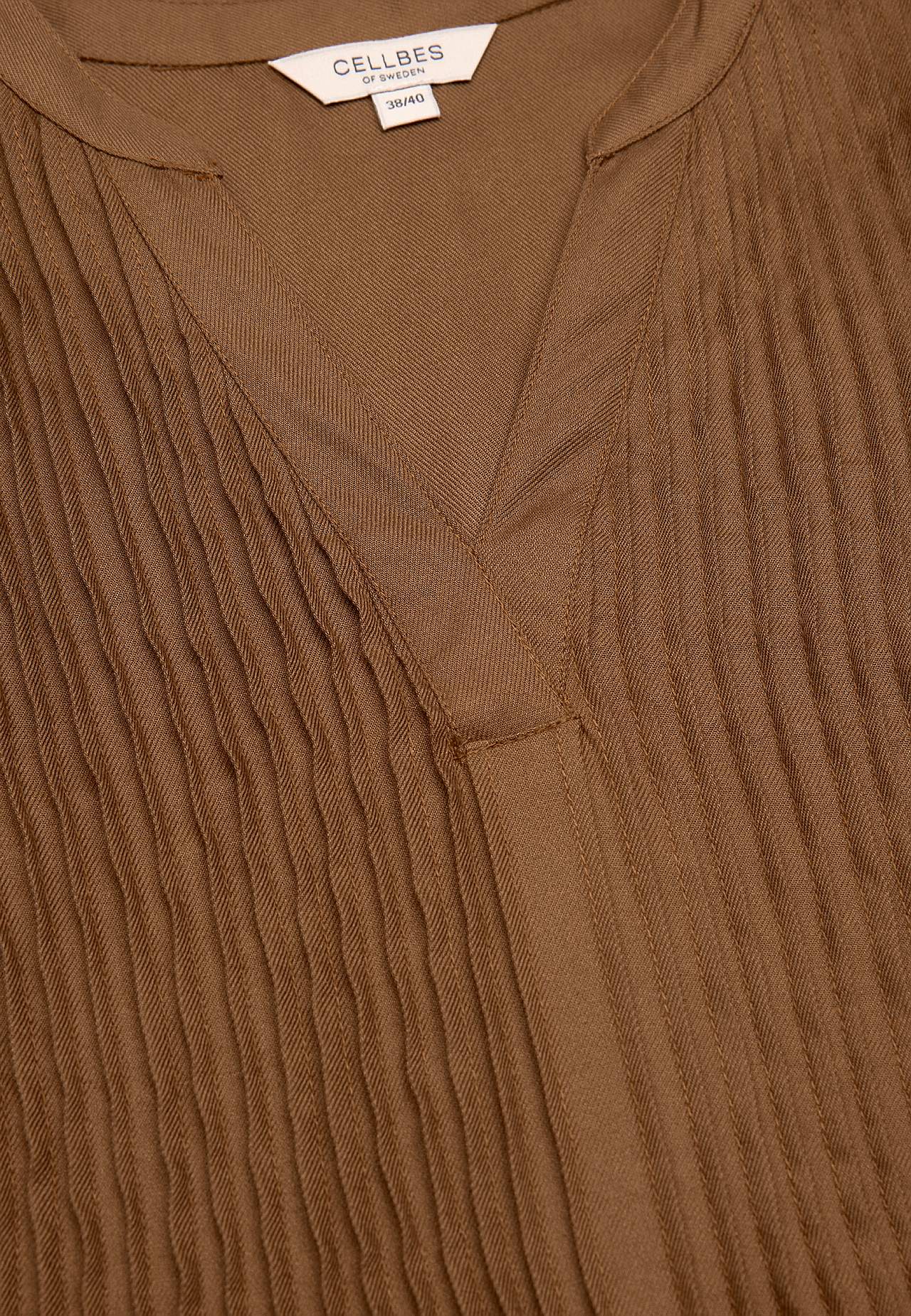 Blouse with stitched pleats
