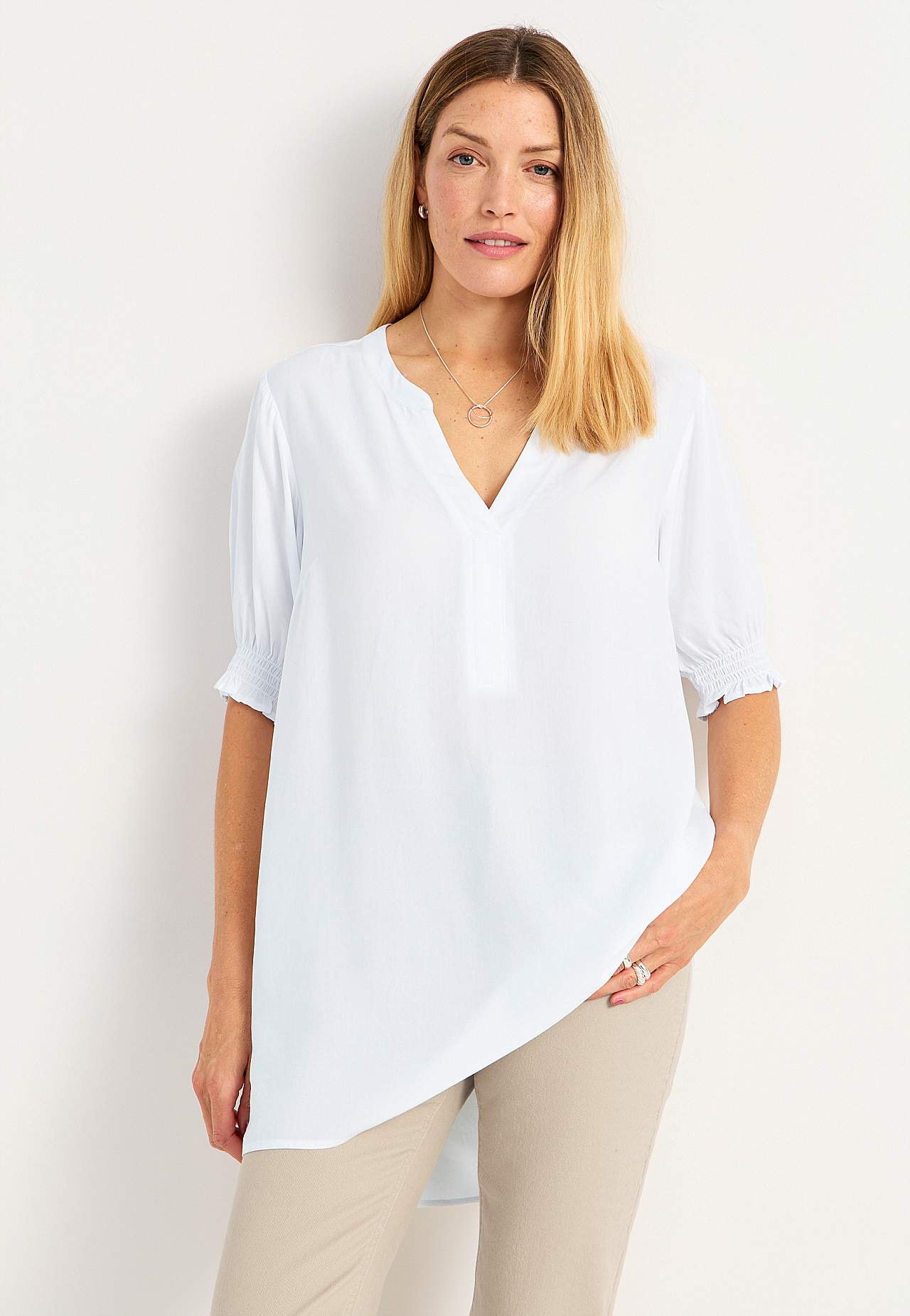 Tunic with smocking on the sleeve ends