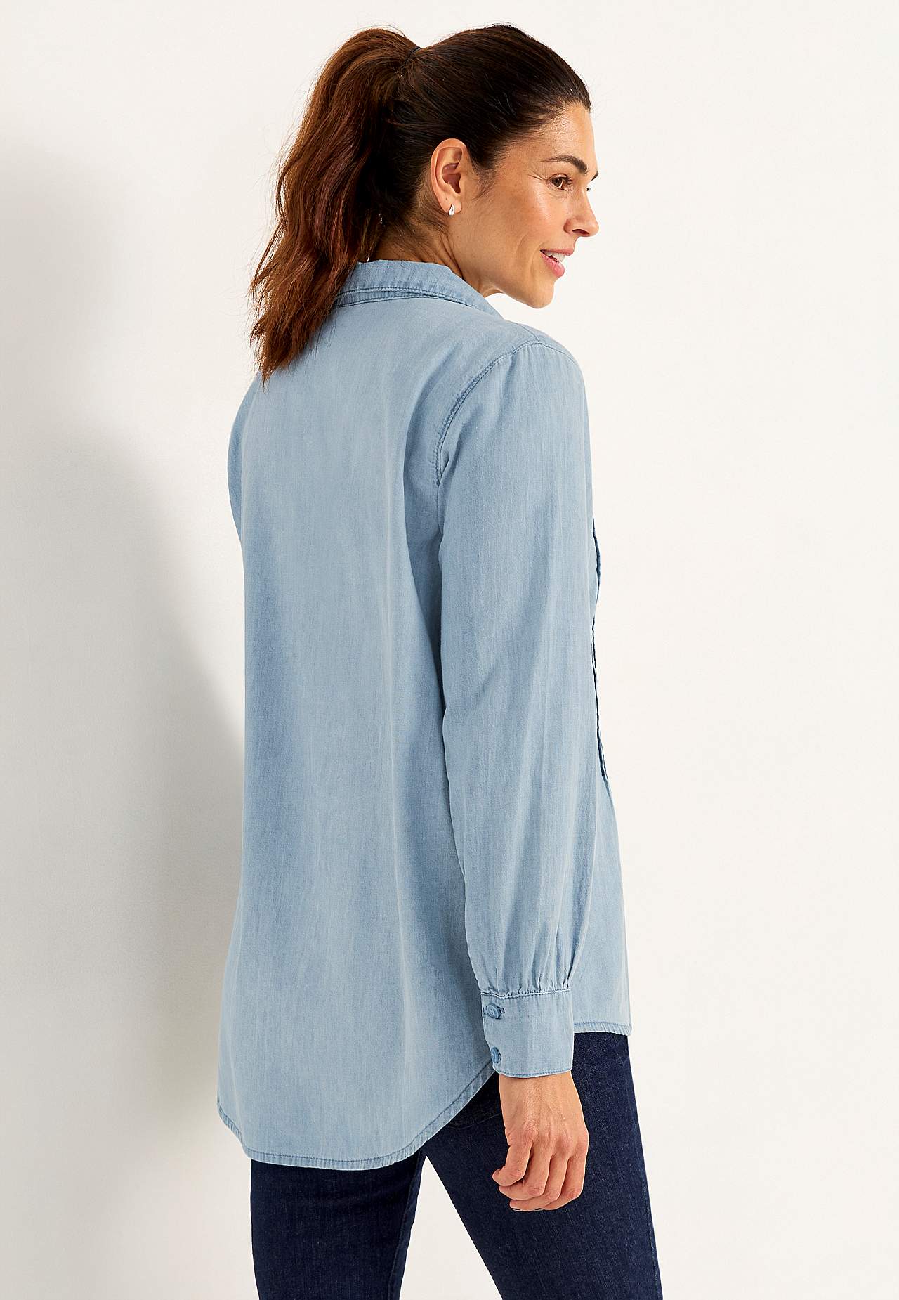 Denim blouse with sewn pleats