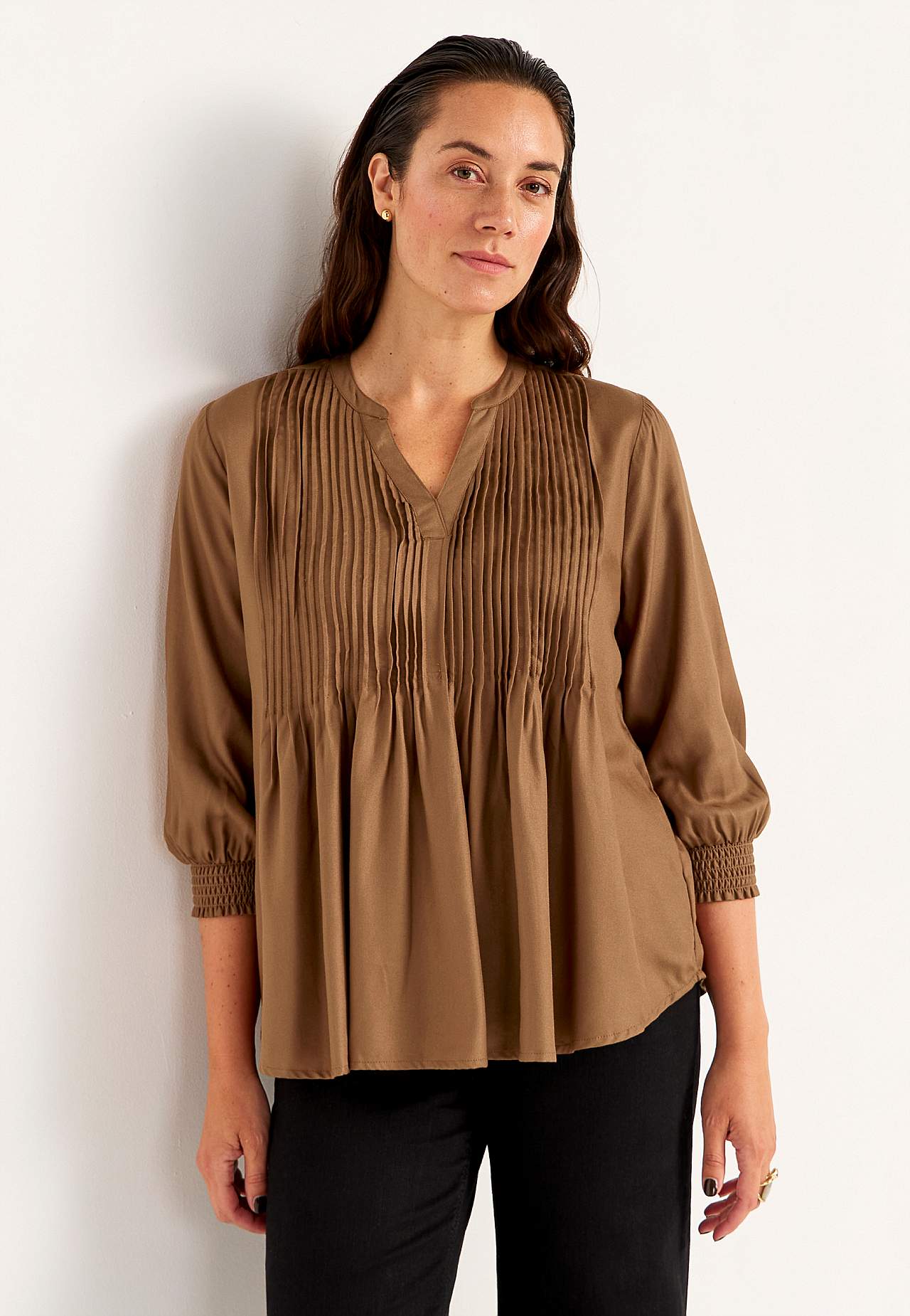Blouse with stitched pleats