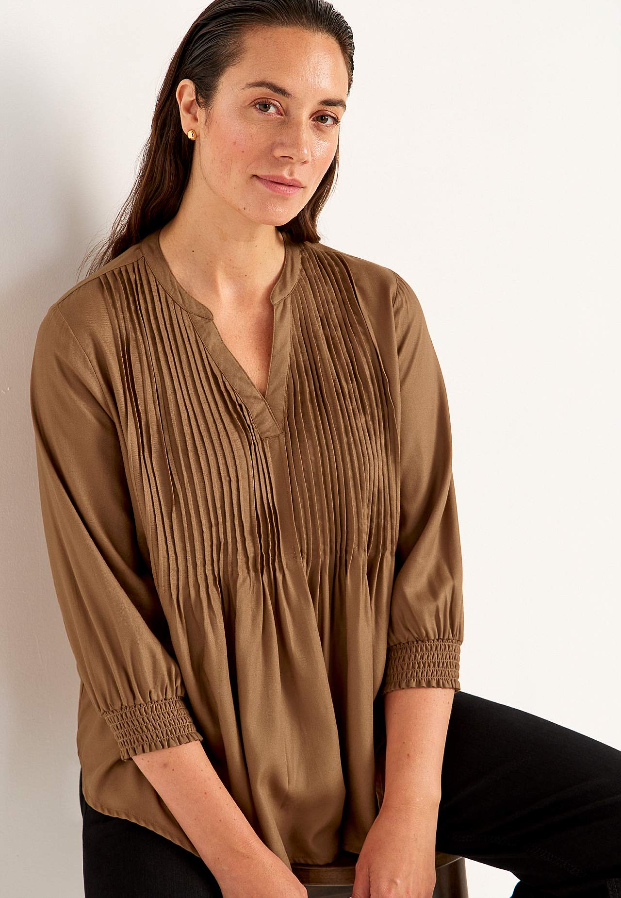 Blouse with stitched pleats